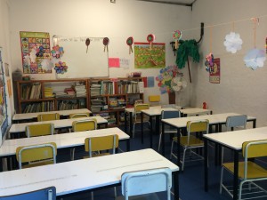 an empty classroom with tables and chairs